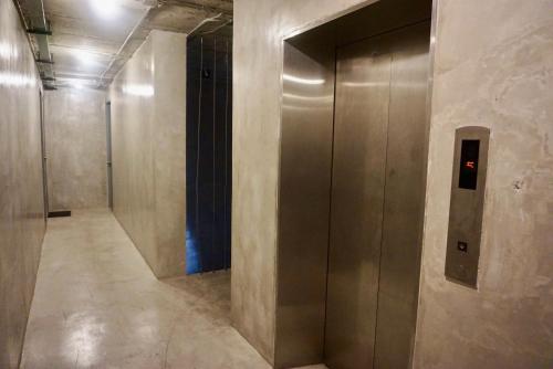 a hallway with a elevator in a building at Hash Capsule Hostel Silom Soi 3 in Bangkok