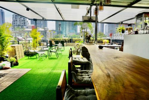 a bar in a building with a green floor at Hash Capsule Hostel Silom Soi 3 in Bangkok