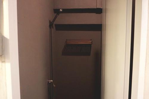 a door with a shelf in a room at Hash Capsule Hostel Silom Soi 3 in Bangkok