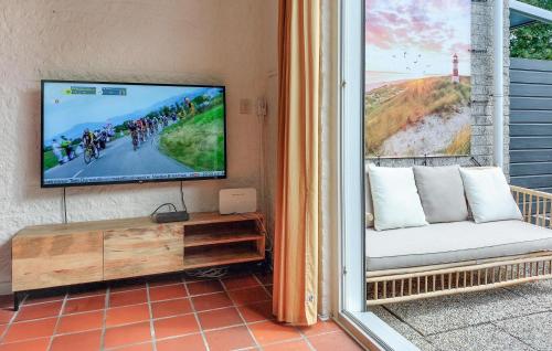 a living room with a tv and a couch at Lovely Home In Kortgene With Sauna in Kortgene