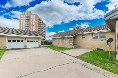 a brick house with a tall building in the background at East Side Oasis 3BR 2 BA Coffee 5Min to Town East in Wichita