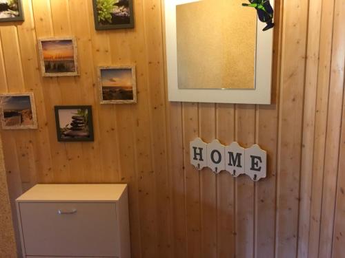 a wall with a home sign and pictures on it at FeWo Eberau in Ebrach