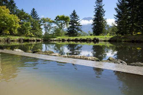 a body of water with rocks in it at Hilton Niseko Village in Niseko