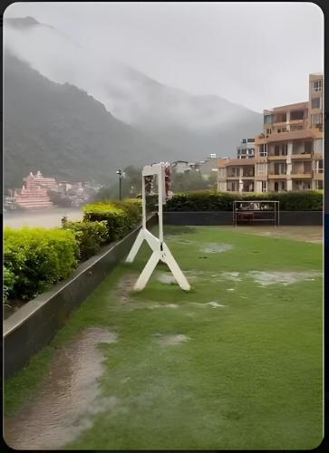 a tripod in a field of grass in a city at Aloha Rishikesh India Apartment by Nibhachi in Rishīkesh