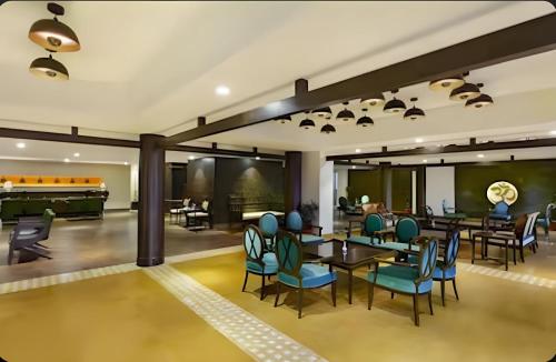 a lobby with tables and chairs and a piano at Aloha Rishikesh India Apartment by Nibhachi in Rishīkesh