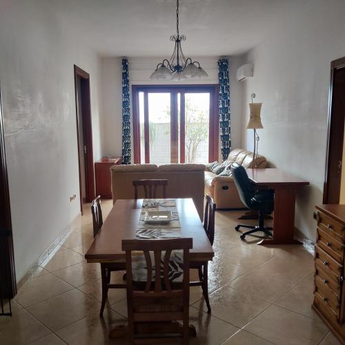 a living room with a table and a couch at CaSaM in Maruggio