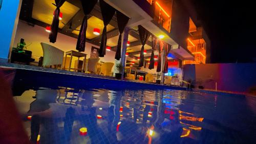 a swimming pool with a reflection in the water at Seaside Stay in Arambol