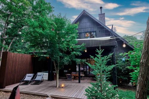 a house with a wooden deck in front of it at SAUNA FOREST CABIN 軽井沢 御代田 A棟 zen-asobi in Oiwake