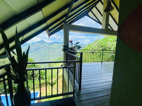a room with a balcony with a view of a mountain at Awesome Place in Ella