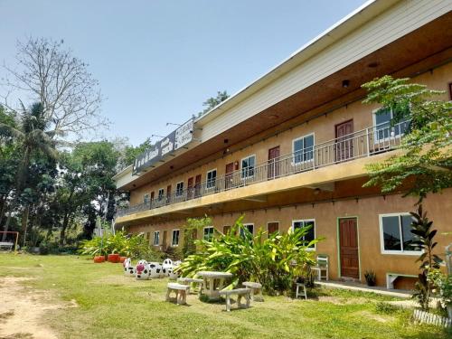 a building with benches in front of it at Jayzada Fang Resort เจซาด้า รีสอร์ท in Fang
