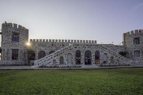 a large stone building with a staircase in the yard at Maya Luxury The Quila Udaipur in Udaipur
