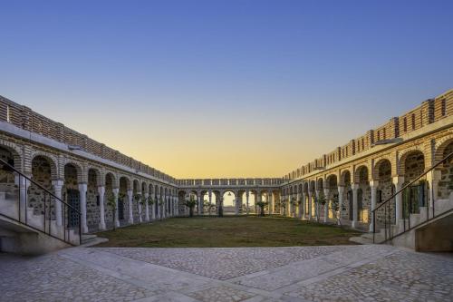 an empty courtyard of a building with a yard at Maya Luxury The Quila Udaipur in Udaipur