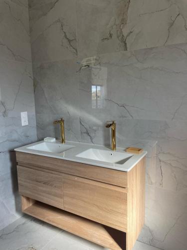 a bathroom with a white tub and a sink at Maison moderne avec Piscine in Creysse