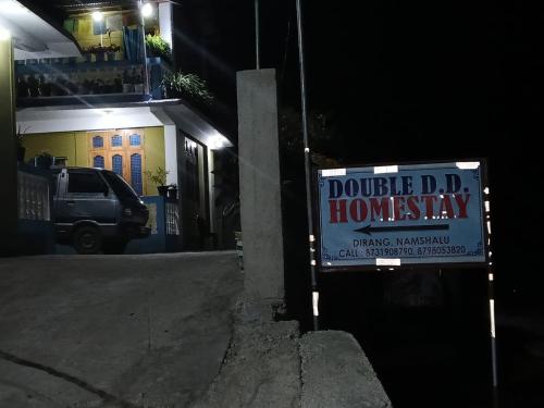 a sign on the side of a street at night at Double D D Homestay in Dirang Dzong