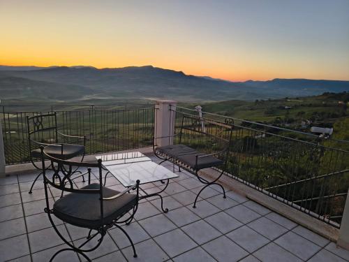a table and chairs on a balcony with a view at Belvedere in Santa Margherita di Belice