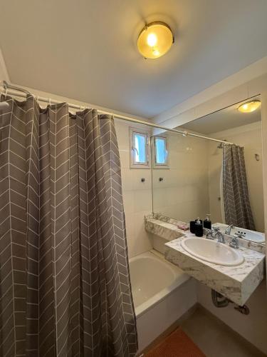 a bathroom with a sink and a tub and a shower at Augusto Apart 3 in Salta