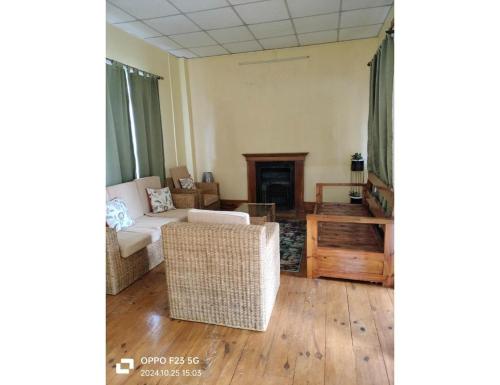a living room with a couch and a table at Le Nessa Guest House, Shillong in Shillong