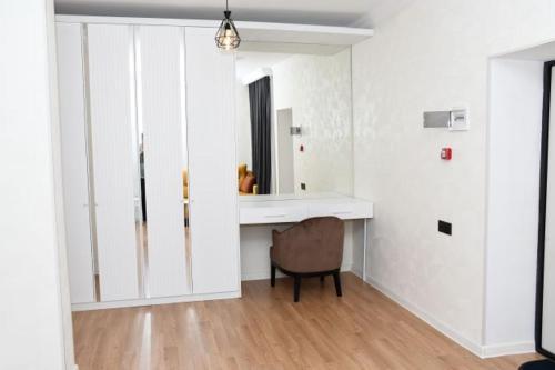 a white room with a desk and a chair at Arena Hotel Gazakh in Qazax