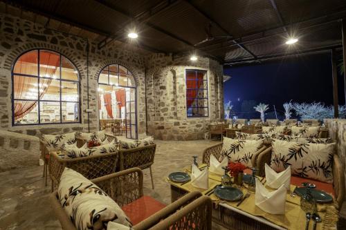 a room with couches and tables in a building at Maya Luxury The Quila Udaipur in Udaipur