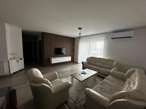 a living room with two couches and a table at ORG Apartment - Ferizaj in Ferizaj
