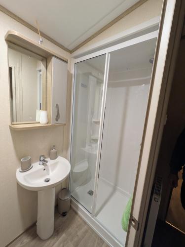a bathroom with a shower and a sink at St Marys Light house, Caravan Rentals in Whitley Bay