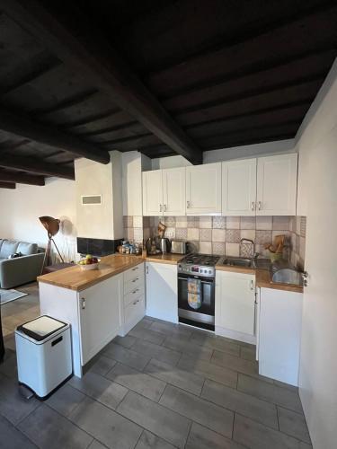 a kitchen with white cabinets and a stove top oven at Drevenica U Feleja in Pohorelá