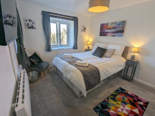 En eller flere senge i et værelse på Corner Cottage at Brackenthwaite Farm