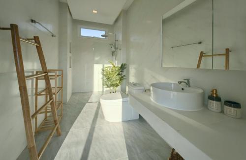 a white bathroom with a sink and a toilet at Happy Palms - Jungle View Villa in Mae Nam