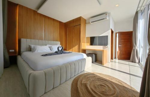 a bedroom with a large white bed in a room at Happy Palms - Jungle View Villa in Mae Nam