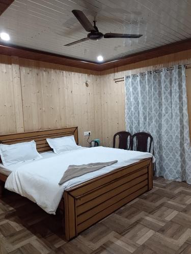 a bedroom with a large bed with a ceiling at Exotic Mount View in Phata