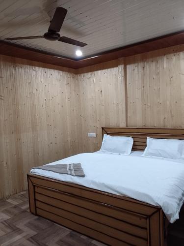 a bedroom with a large bed with a ceiling at Exotic Mount View in Phata