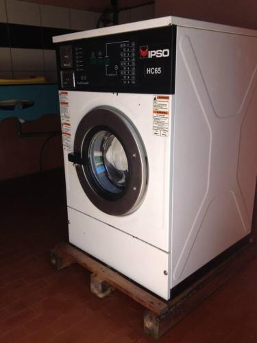 a white washing machine sitting on a cart at Camping U STABIACCIU in Porto-Vecchio