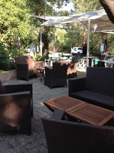 a patio with couches and tables and a tent at Camping U STABIACCIU in Porto-Vecchio