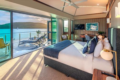 a bedroom with a bed and a view of the water at Yacht Club Villas on Hamilton Island by HIHA in Hamilton Island