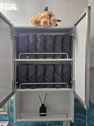 a cupboard with grey chairs and flowers on it at Gamseong house next to Sung Sim Dang in Daejeon