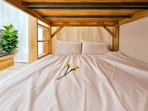 a white bed with two birds sitting on it at Gamseong house next to Sung Sim Dang in Daejeon