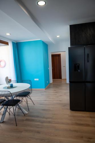 a dining room with a table and a refrigerator at Queen's Penthouse Balchik apartment in Balchik