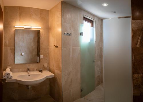 a bathroom with a sink and a shower at Queen's Penthouse Balchik apartment in Balchik
