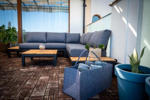 a living room with a blue couch and a table at Queen's Penthouse Balchik apartment in Balchik