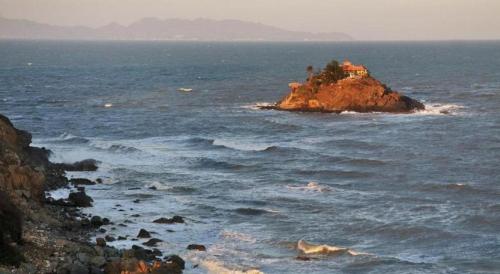 a house on a small island in the ocean at Seventeen Hotel in Vung Tau