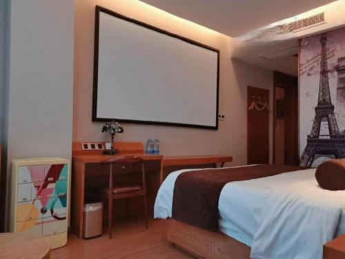 a bedroom with a bed and a large screen at James Joyce Coffetel Tianjin Railway Station Jinshiqiao Metro Station Branch in Tianjin