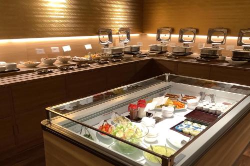 een buffet in een hotelkamer met eten bij ジュラシック スパ &リゾート くつろぎの宿 樹楽 in Toon