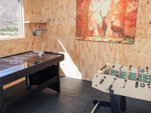 a game room with a table and a game board at Larch in Newtonmore