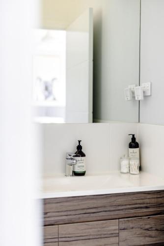 a bathroom counter with a sink and a mirror at Mala Retreat Sleeps 7, Two Bedrooms & Ensuites in East Maitland