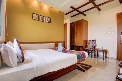 a bedroom with a large bed in a room at FabHotel Khushi Regent - Near DB Mall in Bhopal