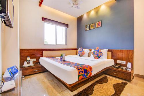 a bedroom with a large bed and a window at FabHotel Khushi Regent - Near DB Mall in Bhopal