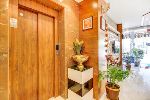a lobby with a vase on a table and plants at FabHotel Khushi Regent - Near DB Mall in Bhopal