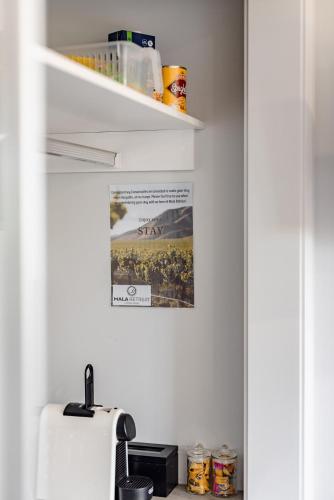 a kitchen with a sink and a refrigerator at Mala Retreat Sleeps 7, Two Bedrooms & Ensuites in East Maitland