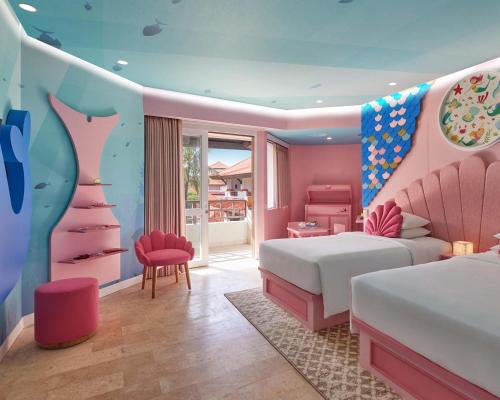 a bedroom with two beds and a pink room at Grand Hyatt Bali in Nusa Dua