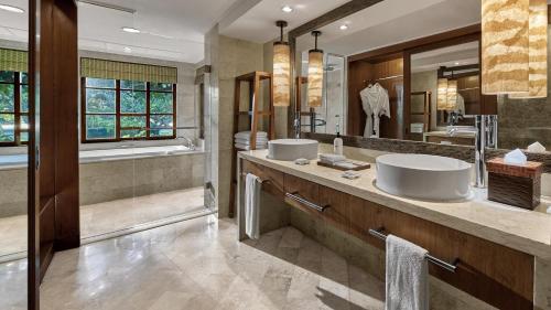 a bathroom with two sinks and a large mirror at Grand Hyatt Bali in Nusa Dua